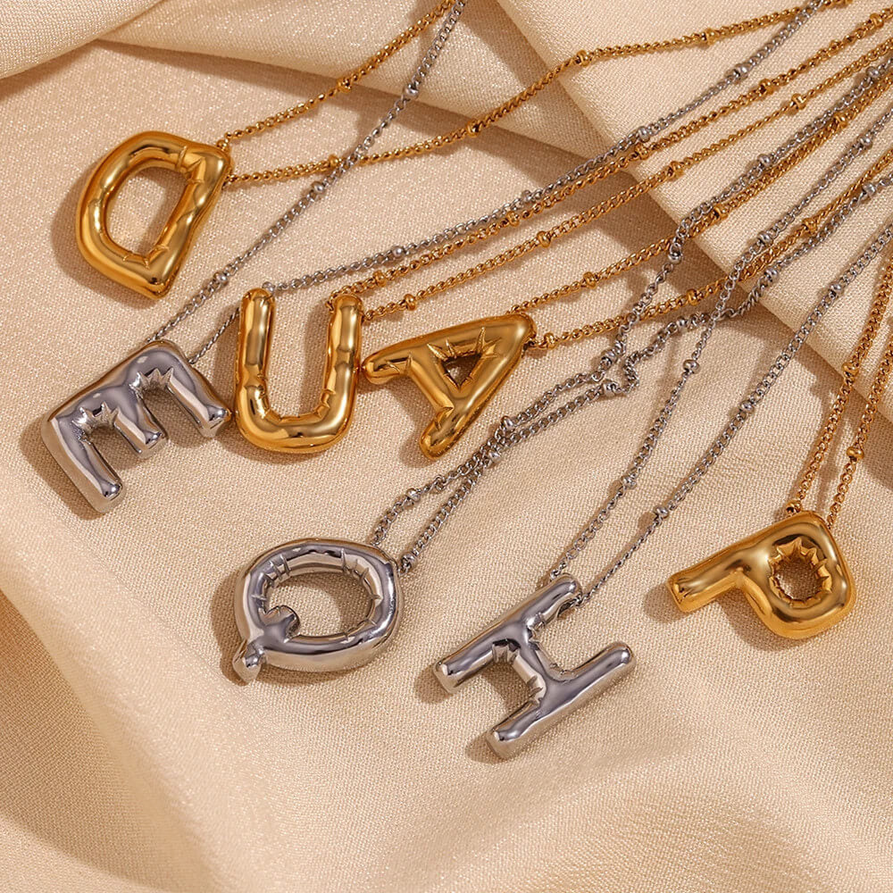 Gold and silver Bubble Letter Necklaces.