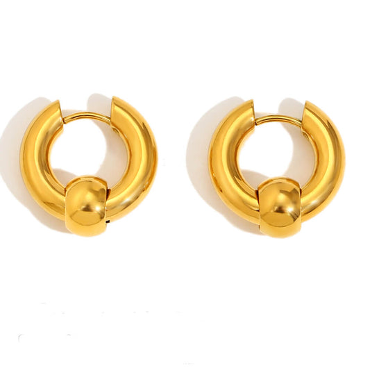 Pair of gold hoop earrings on a white background.