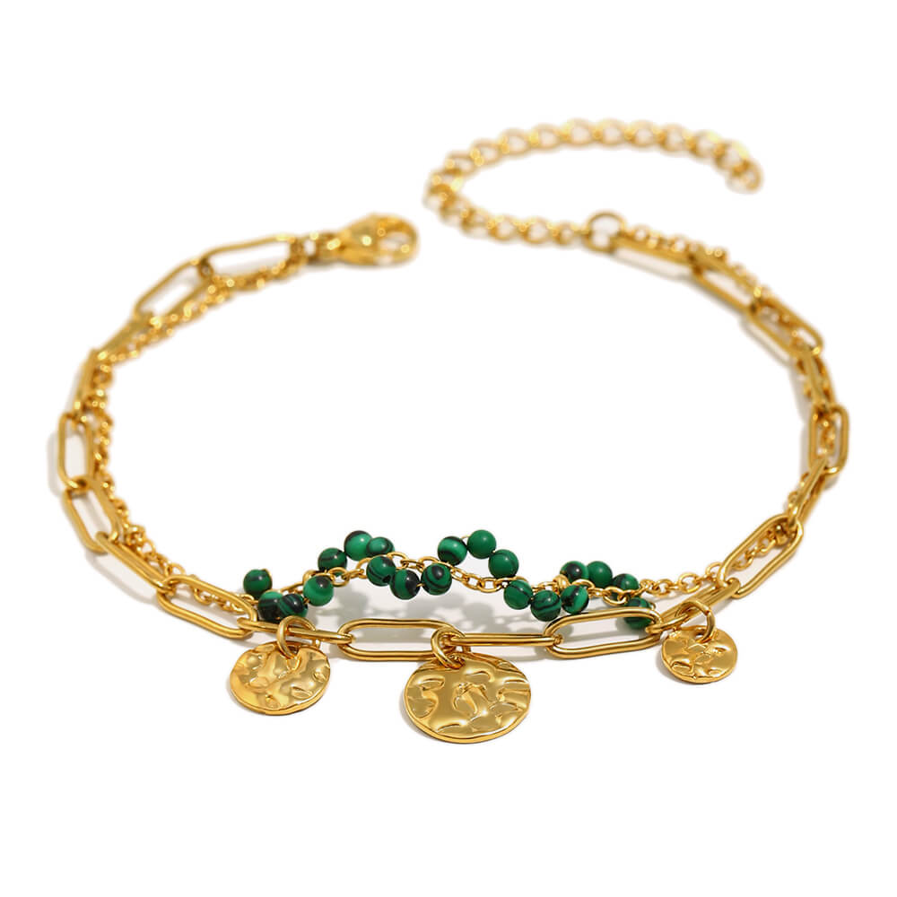 Gold chain and coin bracelet on white background.