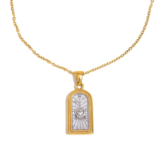 Gold necklace with a pendant featuring a heart design on a white background.