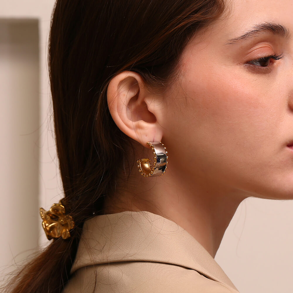 A model wearing the Space Explorer Hoops.