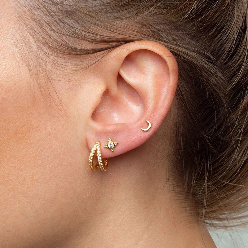 A model wearing the Double CZ Huggie Earrings.