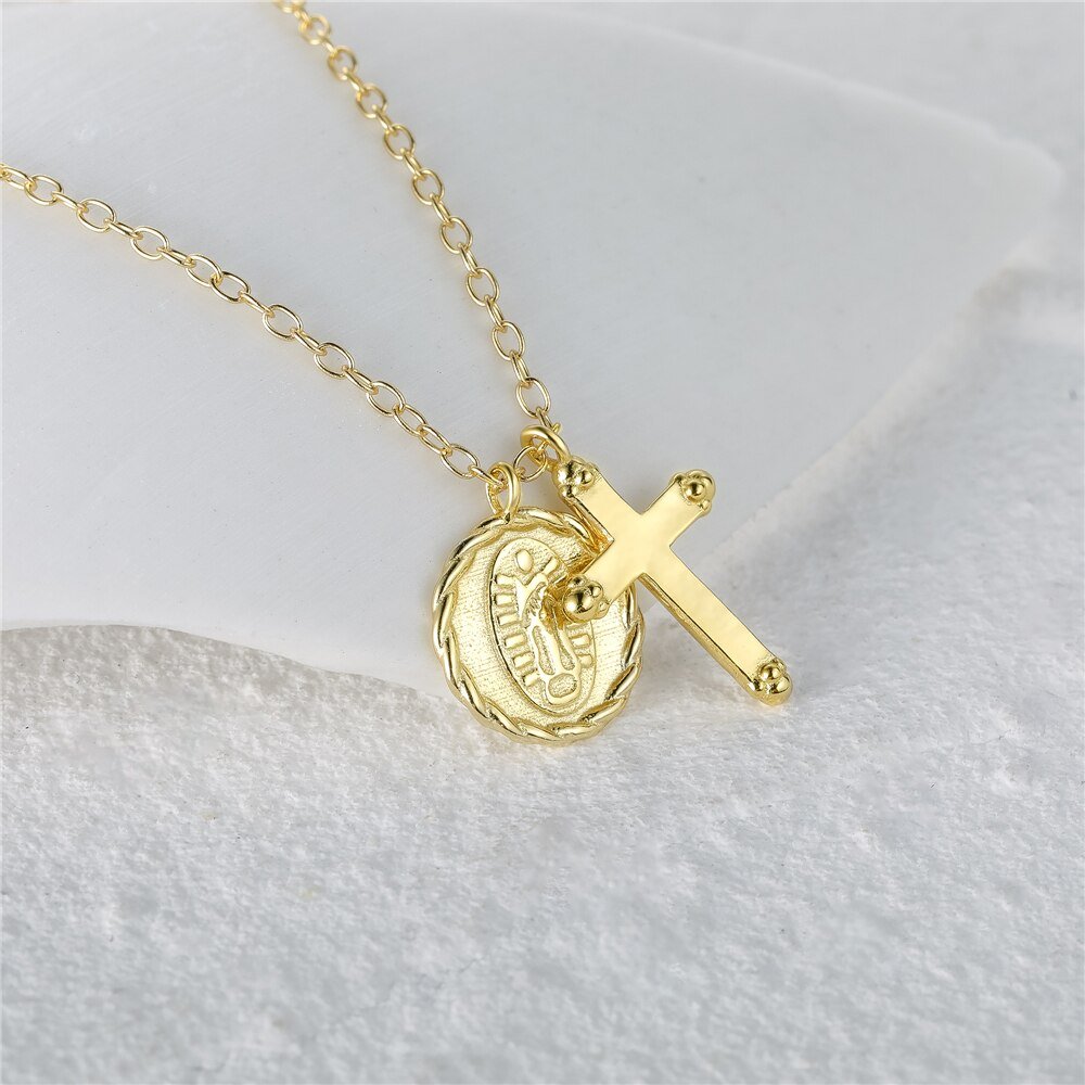 Closeup of the Gold Cross Charm Necklace.