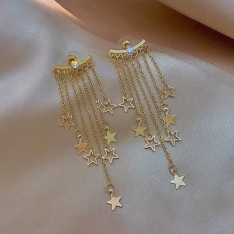Full view of the Gold Star Tassel Statement Earrings.