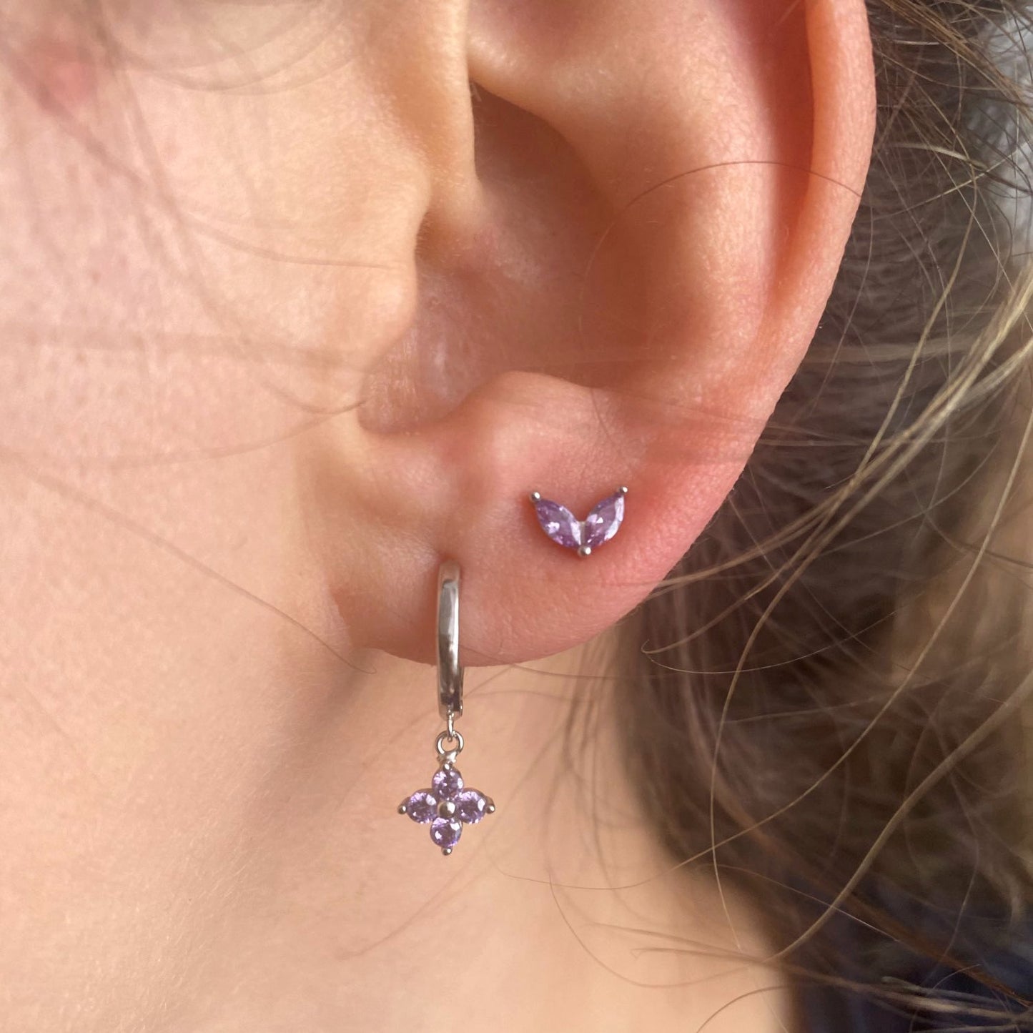 A model wearing the Lilac Flower Huggies with Lilac Marquise Studs.