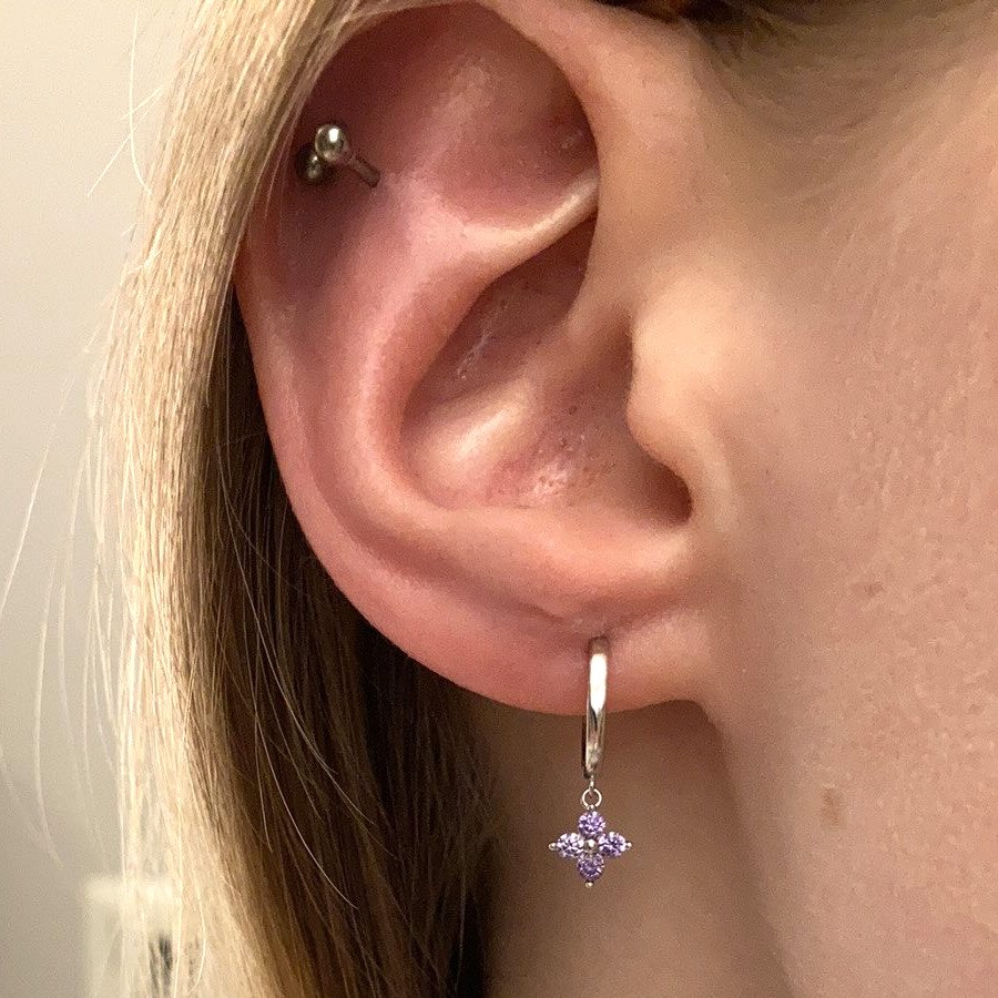 A model wearing silver Lilac Flower Huggies.