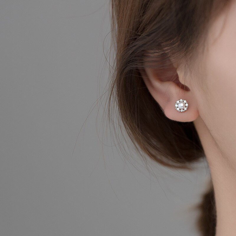 A model wearing the Pearl CZ Halo Studs.