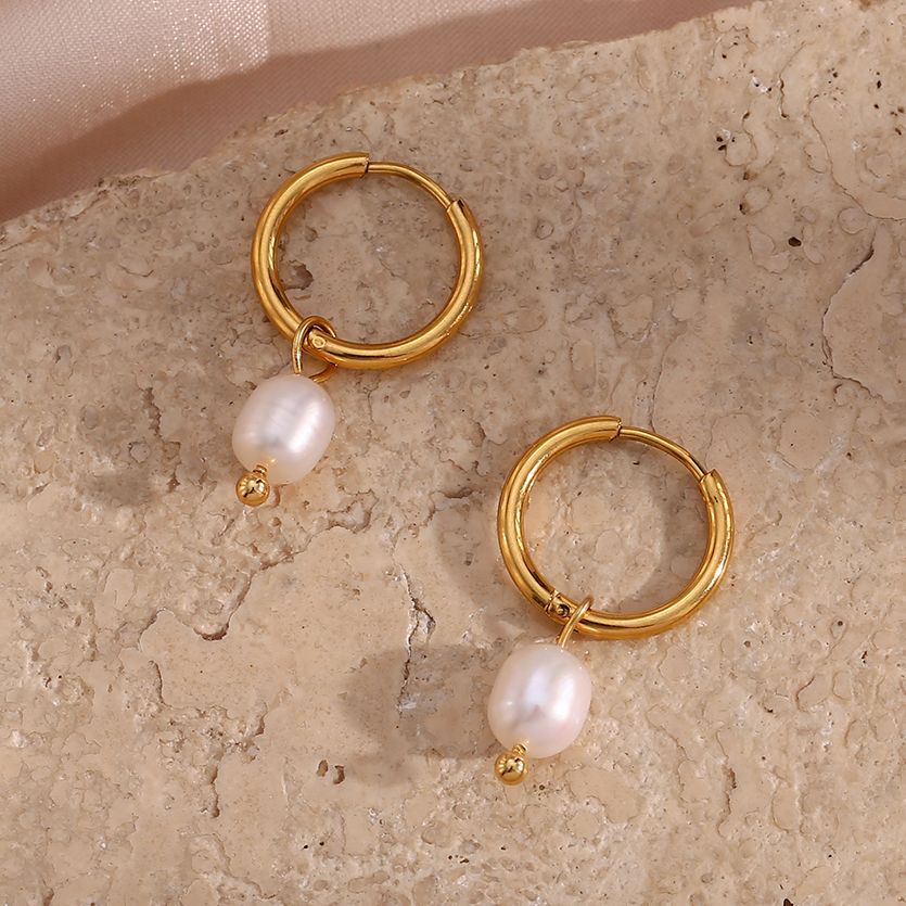 Closeup of the Pearl Dangle Gold Hoops.