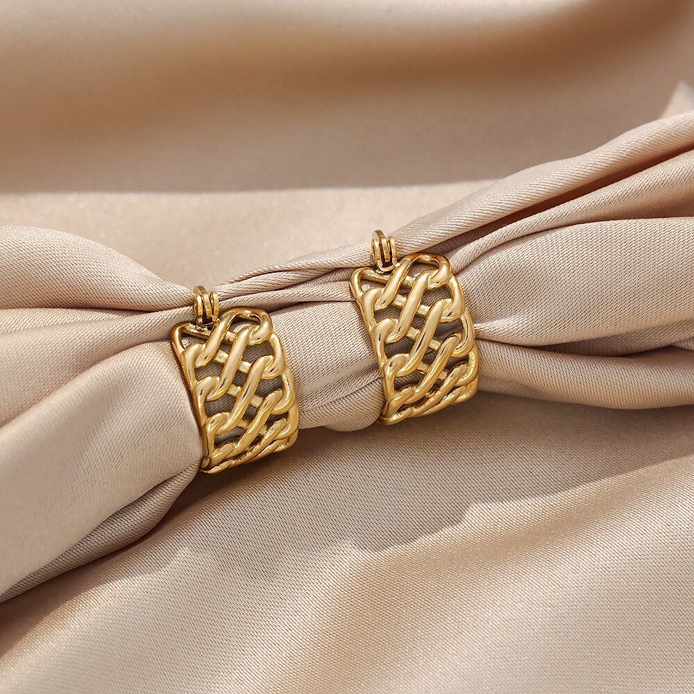 Gold hoop earrings with a woven texture.