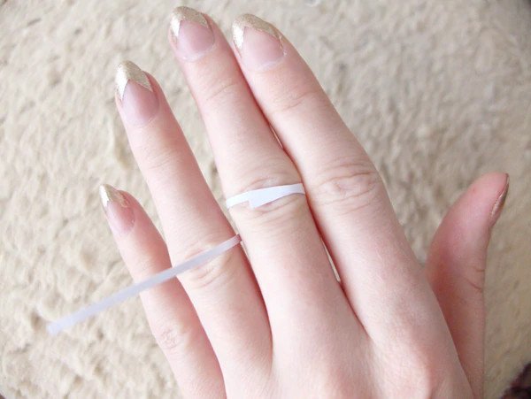 Wrapping a strip of paper around finger.